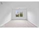 Spacious bedroom with soft carpeting and large sunny window at 6011 Twyckenham Dr, Indianapolis, IN 46236