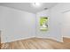 Bedroom with light hardwood flooring and a view to the outdoors at 6011 Twyckenham Dr, Indianapolis, IN 46236