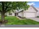 Charming single-story home featuring a two-car garage, well-kept lawn, and tasteful landscaping at 6011 Twyckenham Dr, Indianapolis, IN 46236