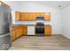 Bright kitchen with stainless steel appliances and wood flooring at 6011 Twyckenham Dr, Indianapolis, IN 46236