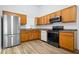 Functional kitchen featuring wood cabinets and modern appliances at 6011 Twyckenham Dr, Indianapolis, IN 46236