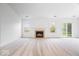 Bright, spacious living room featuring neutral carpet, a cozy fireplace, and natural light at 6011 Twyckenham Dr, Indianapolis, IN 46236