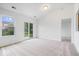 Bright, spacious living room featuring neutral carpet, and natural light through sliding doors at 6011 Twyckenham Dr, Indianapolis, IN 46236