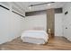 Bright bedroom featuring a bed, barn doors, hardwood floors and lots of natural light at 611 N Park Ave # 108, Indianapolis, IN 46204