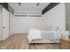 Bright bedroom featuring a bed, barn doors, hardwood floors and lots of natural light at 611 N Park Ave # 108, Indianapolis, IN 46204