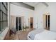 Comfortable bedroom with a large window, a sliding door, and in-unit laundry at 611 N Park Ave # 108, Indianapolis, IN 46204