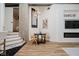 Open-concept dining area with modern light fixture, hardwood floors, and view of the staircase at 611 N Park Ave # 108, Indianapolis, IN 46204