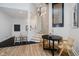 Open-concept area with adjacent kitchen and dining space featuring modern light fixture and staircase at 611 N Park Ave # 108, Indianapolis, IN 46204