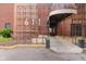 Brick building entrance with a covered walkway and decorative iron number display; planter boxes flank the entrance at 611 N Park Ave # 108, Indianapolis, IN 46204