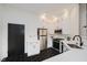 Well-lit kitchen featuring white cabinets, stainless steel appliances, and modern black hexagonal flooring at 611 N Park Ave # 108, Indianapolis, IN 46204