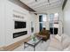 Open living room with large windows, modern furnishings, and a sleek fireplace for a cozy atmosphere at 611 N Park Ave # 108, Indianapolis, IN 46204