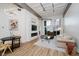 Bright living room with modern furnishings, large windows, hardwood floors, and an electric fireplace at 611 N Park Ave # 108, Indianapolis, IN 46204