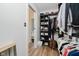 Spacious walk-in closet with custom shelving and wood flooring at 611 N Park Ave # 108, Indianapolis, IN 46204