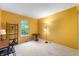 Bedroom featuring yellow walls, large window, desk and shelving at 6263 Behner Way, Indianapolis, IN 46250