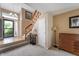Inviting home entryway featuring a staircase, coat closet, and neutral decor at 6263 Behner Way, Indianapolis, IN 46250