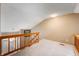 Upstairs hallway with wood railing and a view of the front door at 6263 Behner Way, Indianapolis, IN 46250