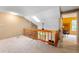 Upstairs hallway with skylight, ceiling fan, and wooden railing at 6263 Behner Way, Indianapolis, IN 46250