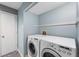 Laundry room with washer, dryer, and blue walls at 6263 Behner Way, Indianapolis, IN 46250