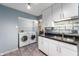 Laundry area with washer, dryer, and modern fixtures at 6263 Behner Way, Indianapolis, IN 46250