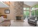 Comfortable living room boasts a stone fireplace, large windows, and vaulted ceilings at 6263 Behner Way, Indianapolis, IN 46250