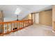 Upstairs loft with stone fireplace, wood banister and multiple entryways to bedrooms at 6263 Behner Way, Indianapolis, IN 46250