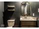 Stylish powder room featuring gold framed mirror, floating shelves, and modern fixtures at 628 Tess Blvd, Westfield, IN 46074