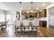 Open kitchen with breakfast bar, stainless steel appliances, and modern pendant lighting at 628 Tess Blvd, Westfield, IN 46074