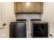 Laundry room with front load washer and dryer and overhead storage cabinets at 628 Tess Blvd, Westfield, IN 46074