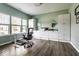 Bright home office with lots of windows, modern desk, hardwood floors, and white storage cabinets at 628 Tess Blvd, Westfield, IN 46074