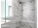 Beautiful walk-in shower with marble-look tile, built-in bench, and glass shelves at 628 Tess Blvd, Westfield, IN 46074