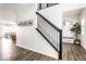 Bright foyer features a staircase with wooden floors and an elegant black banister at 628 Tess Blvd, Westfield, IN 46074