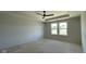 A bright, unfinished primary bedroom features a ceiling fan and plenty of natural light from two windows at 6450 Stone Side Dr, Plainfield, IN 46168