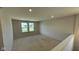 Spacious unfinished room with natural light streaming in from windows, perfect for a future living area at 6450 Stone Side Dr, Plainfield, IN 46168