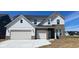 New construction home showcasing a three-car garage, stylish brick accents, and modern architectural details at 6450 Stone Side Dr, Plainfield, IN 46168