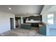 Spacious kitchen with dark green cabinets, an island, and ample natural light creating a modern space at 6450 Stone Side Dr, Plainfield, IN 46168