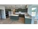 A modern kitchen featuring stylish green cabinetry, an island, and stainless steel appliances at 6450 Stone Side Dr, Plainfield, IN 46168