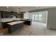 Bright eat-in kitchen boasts stylish green cabinets and ample natural light from surrounding windows at 6450 Stone Side Dr, Plainfield, IN 46168