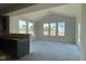 Sunlit living room with high vaulted ceilings, four large windows, and easy access to the kitchen at 6450 Stone Side Dr, Plainfield, IN 46168