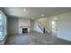 Bright living room with a fireplace, staircase, and large windows, ready for personalization and comfort at 6450 Stone Side Dr, Plainfield, IN 46168