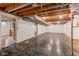Unfinished basement with exposed wood ceiling beams offers potential for customization at 650 W Main St, Carmel, IN 46032