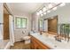 Bathroom features double vanity, tub and shower with natural light at 650 W Main St, Carmel, IN 46032