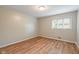 Bright, sunny bedroom with laminate wood floors, large window and neutral walls at 650 W Main St, Carmel, IN 46032