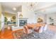 Open dining room features brick fireplace, wood floors, and modern light fixture at 650 W Main St, Carmel, IN 46032