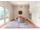 Bright dining room featuring a modern chandelier, decorative fireplace, and large windows with natural light at 650 W Main St, Carmel, IN 46032