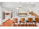 Bright kitchen with white cabinetry, stainless steel appliances, breakfast bar, and warm, wood-look flooring at 650 W Main St, Carmel, IN 46032