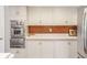 Bright kitchen features stainless steel oven, cabinetry, and eye-catching backsplash at 650 W Main St, Carmel, IN 46032