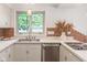 Bright kitchen with stainless steel appliances, updated fixtures, and white cabinets at 650 W Main St, Carmel, IN 46032