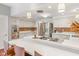 Spacious kitchen with white cabinets, stainless steel appliances, bar seating, and stylish light fixtures at 650 W Main St, Carmel, IN 46032