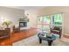 Bright living room features brick fireplace, wood floors, and large windows at 650 W Main St, Carmel, IN 46032
