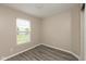 A bedroom with vinyl plank flooring, a window and neutral decor at 671 Greenway St, Greenwood, IN 46143